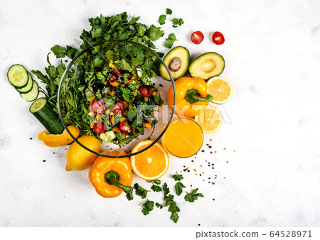 Juicy vegetarian salad at home for a quick bite. Top view. Copy space for text. Juicy vegetarian salad at home for a quick bite. Top view. Copy space for text. 64528971