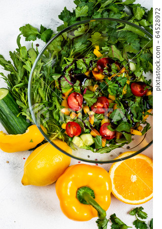 Juicy vegetarian salad at home for a quick bite. Top view. Macro. 64528972