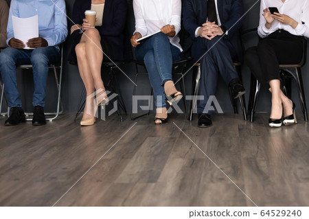 Close up of unrecognizable job applicants waiting for interview 64529240