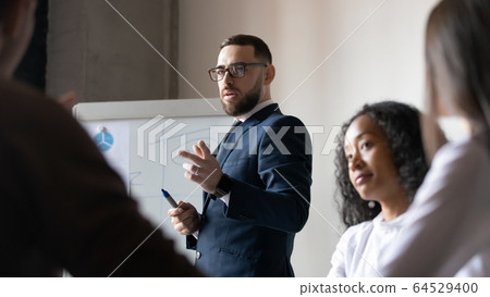 Middle-aged businessman talk male whiteboard presentation at meeting Middle-aged businessman talk male whiteboard presentation at meeting 64529400
