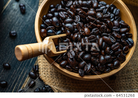 Closeup Fresh Coffee beans in wooden bowl on a bag Closeup Fresh Coffee beans in wooden bowl on a bag 64531268
