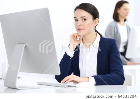 Businesswoman working with computer in office. Lawyer or accountant sitting at work, headshot. Business concept Businesswoman working with computer in office. Lawyer or accountant sitting at work, headshot. Business concept 64533294