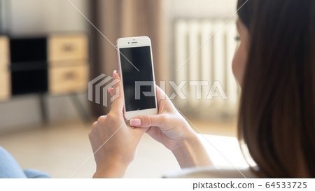 Mock up smartphone screen of young woman holding mobile device. 64533725