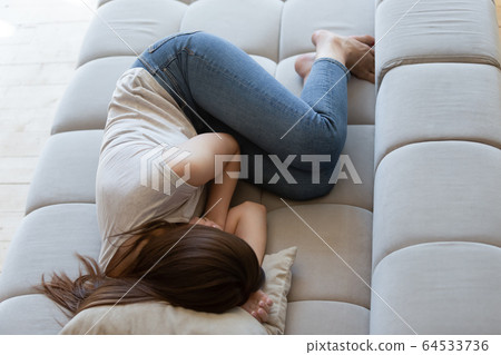 Tired after sleepless night young woman lying and resting. 64533736