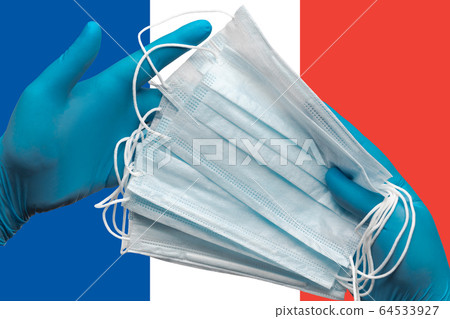 Doctor holds face masks in hands blue gloves on background national flag of France. Concept quarantine, hygiene, pandemic outbreak. Surgical antibacterial face bandage Doctor holds face masks in hands blue gloves on background national flag of France. Concept quarantine, hygiene, pandemic outbreak. Surgical antibacterial face bandage 64533927