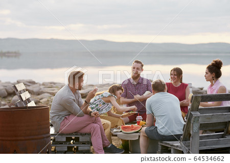 Friends Spending Evening Outdoors Friends Spending Evening Outdoors 64534662
