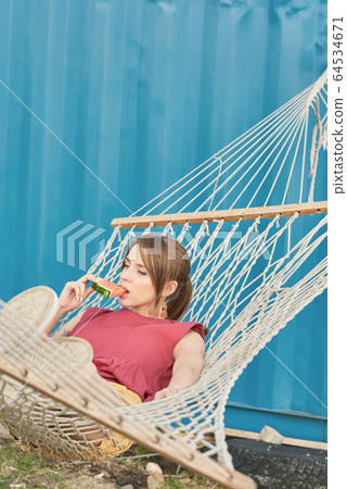 Girl Eating Watermelon In Hammock Girl Eating Watermelon In Hammock 64534671