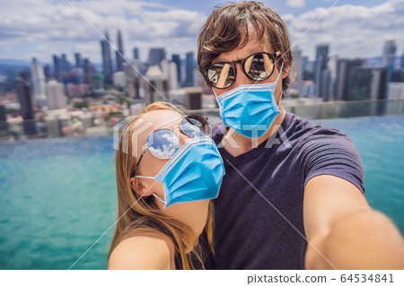 young happy and attractive playful couple in medical mask taking selfie picture together at luxury young happy and attractive playful couple in medical mask taking selfie picture together at luxury 64534841