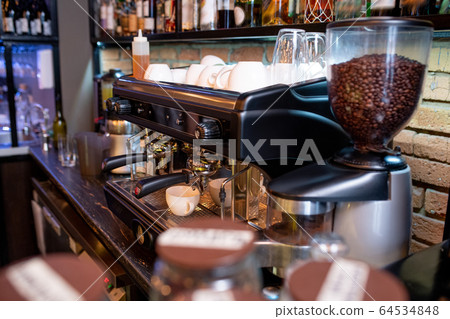 Workplace of contemporary barista with coffee machine and clean cups Workplace of contemporary barista with coffee machine and clean cups 64534848