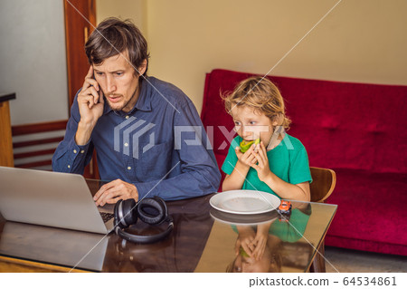 Man is trying to work from home because of the coronovirus epidemic, but his son is stopping him 64534861
