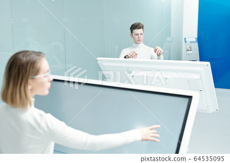 Two young progressive software developers looking through database Two young progressive software developers looking through database 64535095