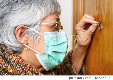 Covid-19 concept. Stay at home. Self-isolation to prevent the coronavirus pandemic. Senior woman in 64535397
