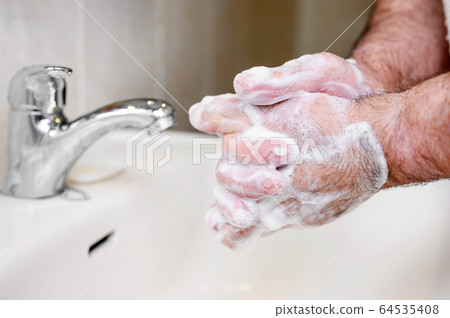 Close up of Senior man washing his hands using soap foam, Prevention from covid19, Coronavirus or Close up of Senior man washing his hands using soap foam, Prevention from covid19, Coronavirus or 64535408