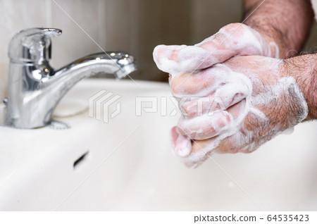 Close up of Senior man washing his hands using soap foam, Prevention from covid19, Coronavirus or Close up of Senior man washing his hands using soap foam, Prevention from covid19, Coronavirus or 64535423
