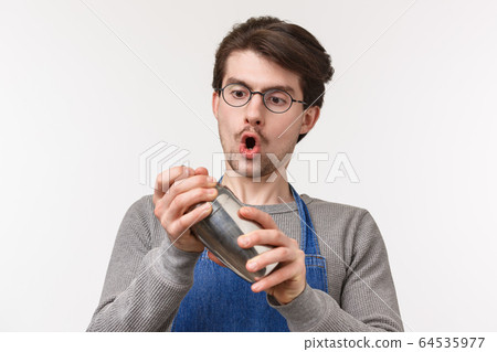 Close-up portrait of enthusiastic dedicated young male employee, bartender likes making drinks, shaking cocktail in shaker with passion, standing excited white background Close-up portrait of enthusiastic dedicated young male employee, bartender likes making drinks, shaking cocktail in shaker with passion, standing excited white background 64535977