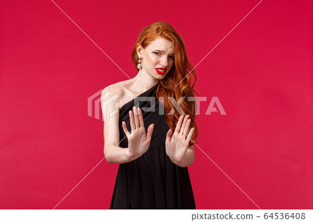 Fashion, luxury and beauty concept. Portrait of redhead elegant woman feeling uncomfortable with drunk person trying pick her up, move away show stop, refusal gesture, rejecting something disgusting 64536408