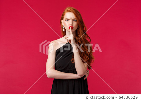 Fashion, luxury and beauty concept. Portrait of angry and displeased young redhead woman shushing at person talking too loud, frowning and grimaicng disappointed, tell be quiet 64536529