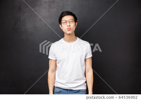 Relationship, romance and couple concept. Cute silly asian boyfriend close eyes and pouting lips prepared for first kiss, want to giggle and smile, having his first date with girl he loves 64536902