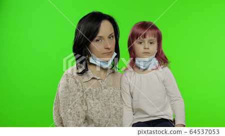 Sick mother and daughter in medical mask. Coronavirus concept. Family quarantine Sick mother and daughter in medical mask. Coronavirus concept. Family quarantine 64537053