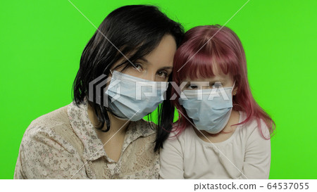 Sick mother hug daughter in medical mask. Coronavirus concept. Family quarantine 64537055