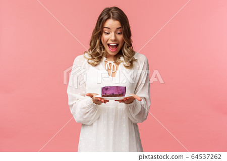 Holidays, spring and party concept. Portrait of happy and excited young blond girl decided start day with sweets, look amazed and cheerful and piece of delicious cake, cant wait to eat it Holidays, spring and party concept. Portrait of happy and excited young blond girl decided start day with sweets, look amazed and cheerful and piece of delicious cake, cant wait to eat it 64537262