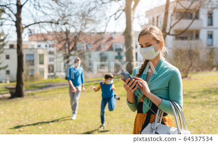 People during covid-19 crisis looking for news on their phones 64537534
