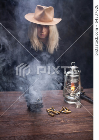 wild west blonde girl shooting from revolver gun wild west blonde girl shooting from revolver gun 64537626