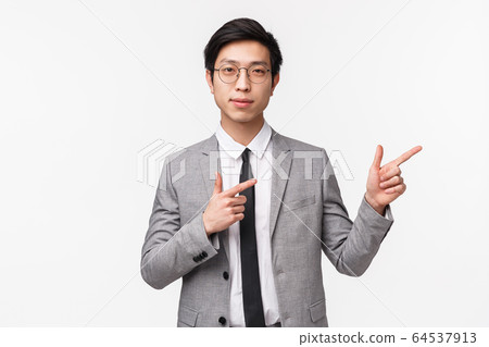 Waist-up portrait of confident, smart handsome asian businessman leading presentation, lecture for office workers, wearing suit, pointing fingers upper right corner and look camera determined Waist-up portrait of confident, smart handsome asian businessman leading presentation, lecture for office workers, wearing suit, pointing fingers upper right corner and look camera determined 64537913