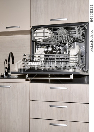 Opened dishwasher with dishes, built at the level 64538331