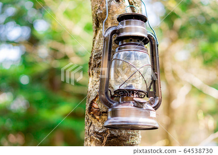 Camping material Oil lantern hanging on a tree 64538730
