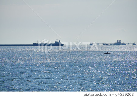 Photographing the scenery of a freighter anchored off the coast of Tomakomai Port in Tomakomai City, Hokkaido in spring Photographing the scenery of a freighter anchored off the coast of Tomakomai Port in Tomakomai City, Hokkaido in spring 64539208