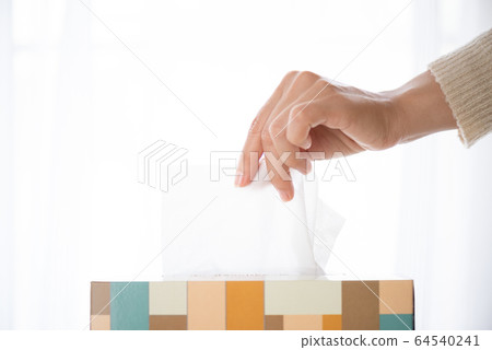 Woman hand picking white tissue paper 64540241