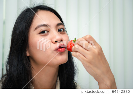 Woman eat strawberry red berry fruit sweet juicy Woman eat strawberry red berry fruit sweet juicy 64542880