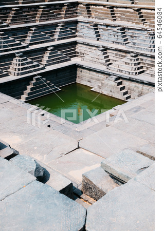 Pushkarani Stepped Tank, Ancient ruins in Hampi, India Pushkarani Stepped Tank, Ancient ruins in Hampi, India 64546084