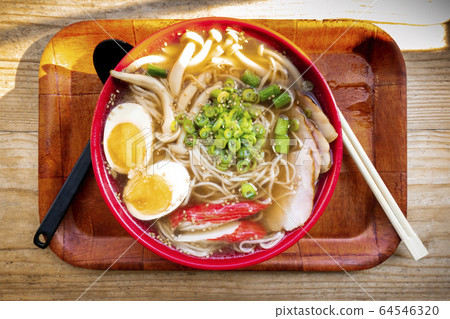 Tonkotsu ramen close-up, shot from the top, with eggs, green onion and mushrooams, with chopsticks on a tray 64546320