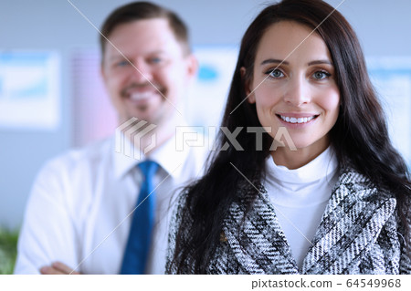 Happy man and woman office workers smiling at work 64549968