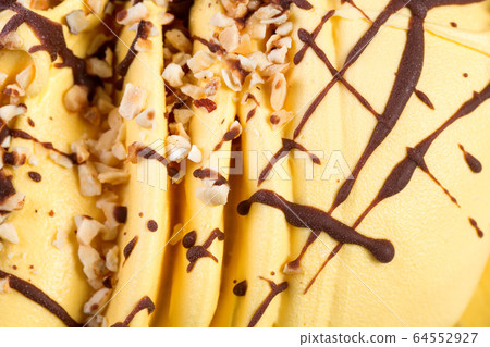 Slices of orange ice-cream with nuts close up. 64552927