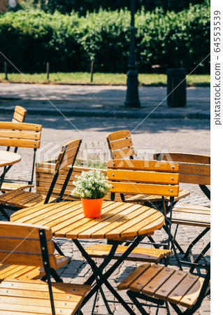 Street cafe empty chair and table in Gdansk, Poland 64553539