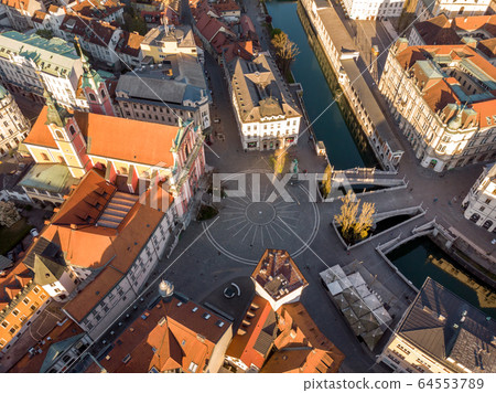 Aerial drone view of Preseren Squere and Triple Bridge over Ljubljanica river,Tromostovje, Ljubljana, Slovenia. Empty streets during corona virus pandemic social distancing measures Aerial drone view of Preseren Squere and Triple Bridge over Ljubljanica river,Tromostovje, Ljubljana, Slovenia. Empty streets during corona virus pandemic social distancing measures 64553789