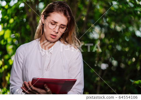 Young female agricultural engineer working in greenhouse. 64554106