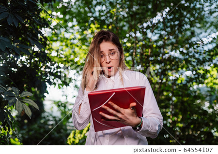 Young female agricultural engineer working in greenhouse. 64554107