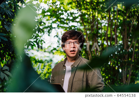 Nature protection concept. Male scientist looking at the camera Nature protection concept. Male scientist looking at the camera 64554138