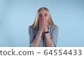 Blonde female widely opening her mouth in astonishment 64554433