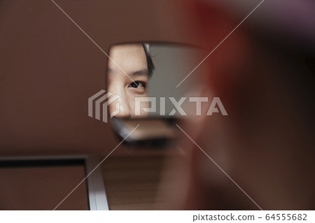 A beautiful eye in the mirror. 64555682