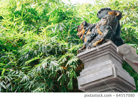 Traditional sculpture and trees at Den ngoc son temple in Hanoi, Vietnam 64557080