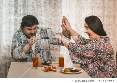 Plus Size Woman Feeding Her Husband Healthy Food 64558667