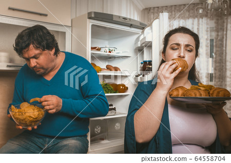 Body Positive Couple Having Fun With Unhealthy Eating Body Positive Couple Having Fun With Unhealthy Eating 64558704
