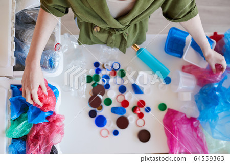 Woman Sorting Plastic at Home Above View Woman Sorting Plastic at Home Above View 64559363