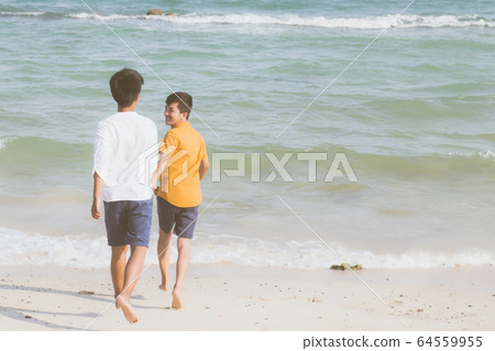 Homosexual portrait young asian couple running with cheerful together on beach in summer Homosexual portrait young asian couple running with cheerful together on beach in summer 64559955
