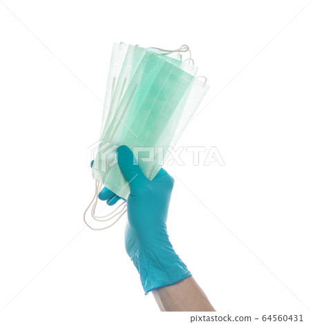 Hand in blue doctor gloves giving Medical mask Hand in blue doctor gloves giving Medical mask 64560431